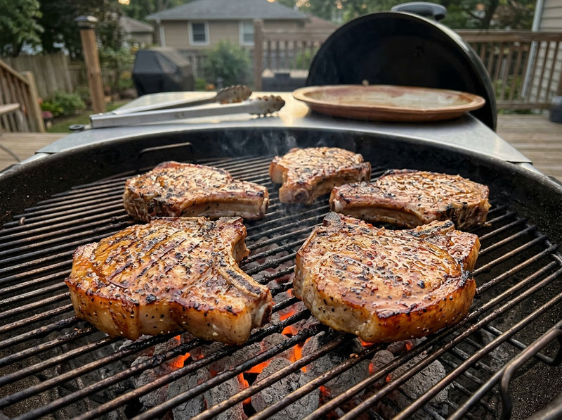 Thick bone-in grilled pork chops with dark grill marks
