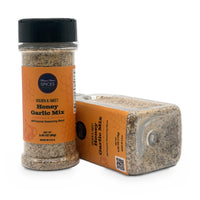 Honey Garlic Mix 9.5 oz bottle lying beside the smaller jar